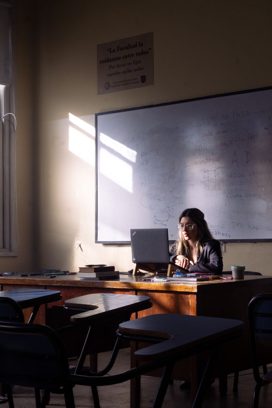 female teacher working in sunlit classroom